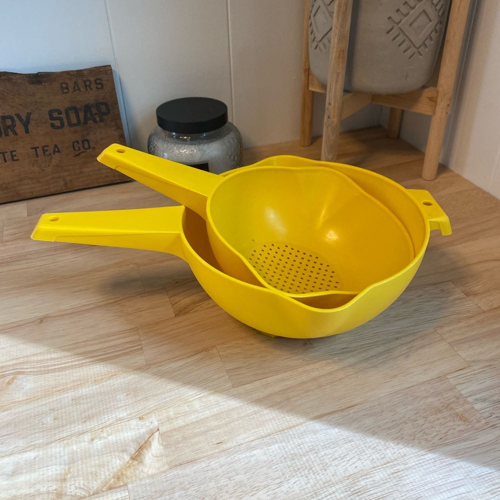 set of two yellow vintage Tupperware strainers